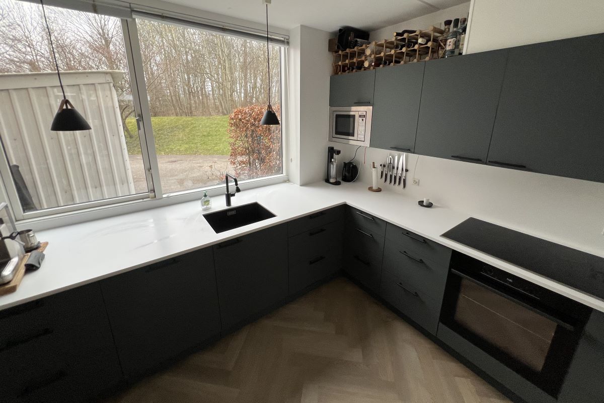 køkkenfornyelse det færdige resultat med corian bordplade og fronter i fenix laminat